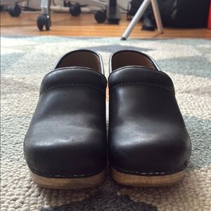 Dansko black leather clogs in good condition